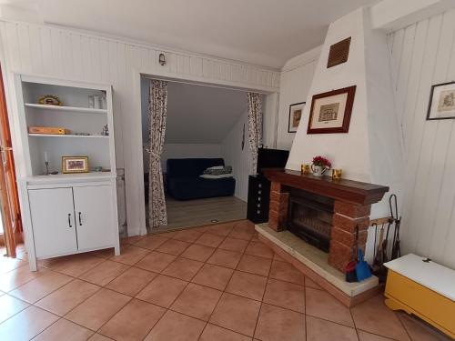 a living room with a fireplace and a couch at Mansarda Eiretta in Ceres