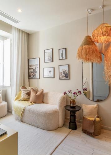 a living room with a couch and a mirror at Chic and modern apartment with yard LDEM1-2 in Sliema