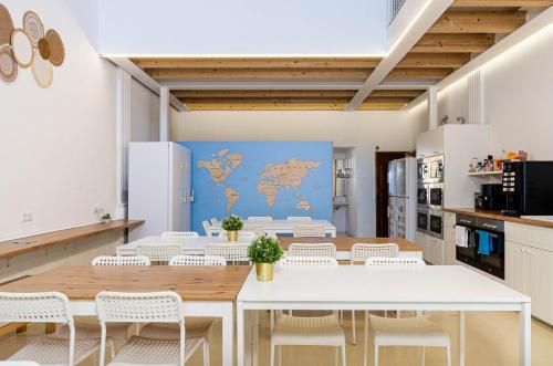 a dining room with a white table and white chairs at Urban Hostel Palma - Albergue Juvenil - Youth Hostel in Palma de Mallorca