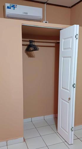 a closet with a white door and a vent at Villas del Edén in El Pino