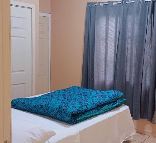 a blue blanket sitting on a bed in a room at Villas del Edén in El Pino