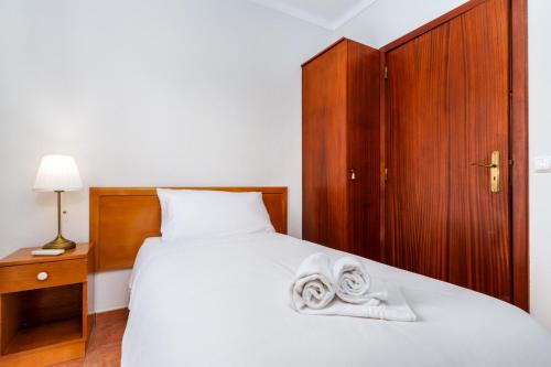 a bedroom with a bed with towels on it at Hotel Salatia in Alcácer do Sal