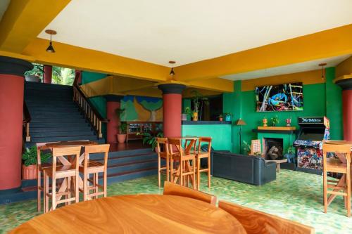 a room with a table and chairs and a fireplace at Lake Arenal Hotel & Brewery in Tilarán