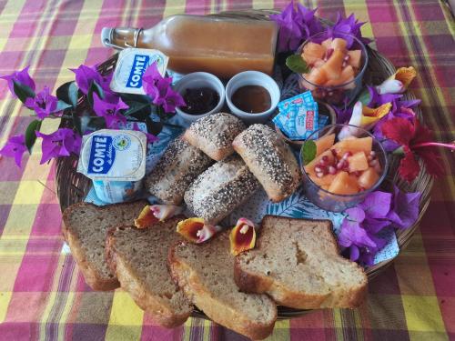 a basket of bread and some dips and some flowers at Blue Kaz Caraïb in Pointe-Noire