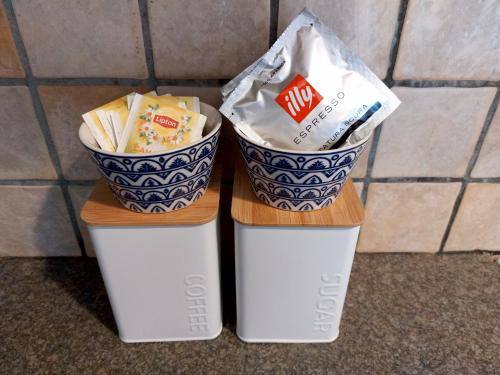 two take out containers with a bag of chips at ATHENA'S Central APP in Samos