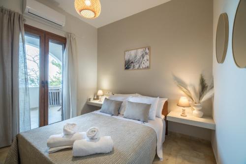 a bedroom with a bed with towels on it at Platani Seaside Villa in Sitia