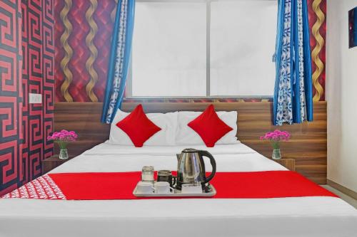 a hotel room with a bed with a blender on it at SPOT ON Swarg Executive Paradise Near Fun Time Multiplex in Māngvādi