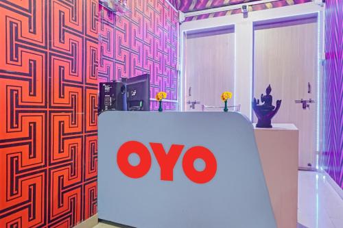 a omo sign in a room with a wall at SPOT ON Swarg Executive Paradise Near Fun Time Multiplex in Māngvādi