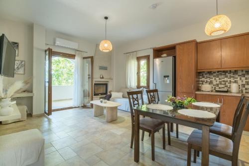 a kitchen and living room with a table and chairs at Platani Seaside Villa in Sitia