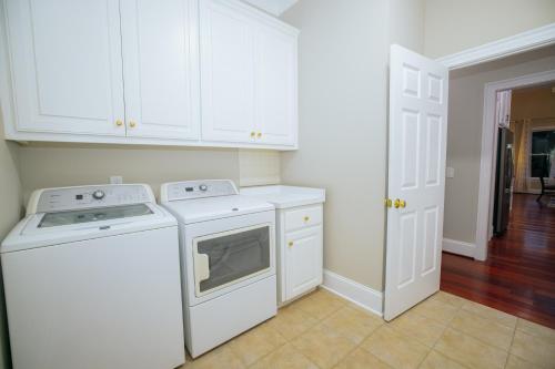 a kitchen with white cabinets and a dishwasher at Beautiful Estate in 19 acres of land in Apex in Apex