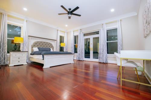 a bedroom with a bed and a ceiling fan at Beautiful Estate in 19 acres of land in Apex in Apex
