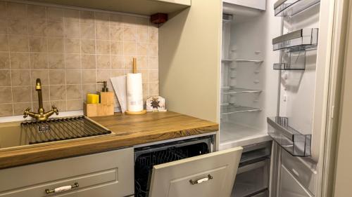 a kitchen with a counter and a refrigerator at Locul cu Amintiri in Albac