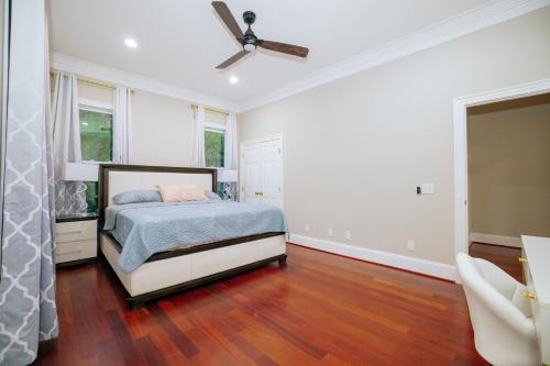 a bedroom with a bed and a ceiling fan at Beautiful Estate in 19 acres of land in Apex in Apex