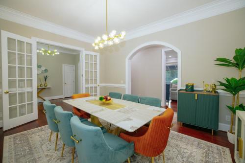 a dining room with a table and blue chairs at Beautiful Estate in 19 acres of land in Apex in Apex