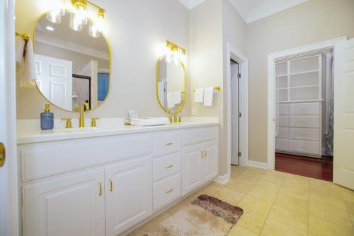 a white bathroom with a sink and two mirrors at Beautiful Estate in 19 acres of land in Apex in Apex