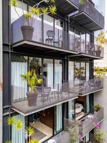 an apartment building with balconies and tables and chairs at MX Grand Suites in Mexico City