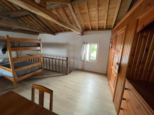 a room with two bunk beds and a table at Casa na praia- Maia in Maia