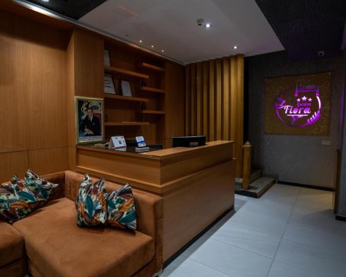 a hotel lobby with a reception desk and couches at Hotel Golden Flora in Beni Mellal