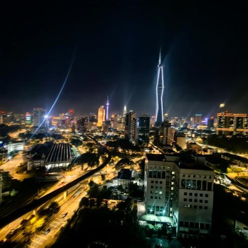 a city skyline at night with a tall building at KL Sentral Dua Sentral Cozy Homestay Apartments by Hollywood Homes #FreeCarPark in Kuala Lumpur