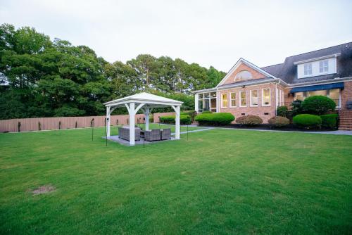 a gazebo in a yard in front of a house at Beautiful Estate in 19 acres of land in Apex in Apex