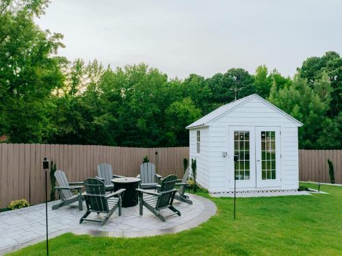 a white shed with chairs and a table in a yard at Beautiful Estate in 19 acres of land in Apex in Apex