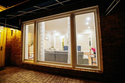 a large window of a living room with a couch at Beautiful Estate in 19 acres of land in Apex in Apex