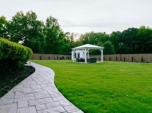 a white gazebo in a grassy yard at Beautiful Estate in 19 acres of land in Apex in Apex