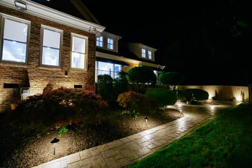 a house at night with a pathway in front of it at Beautiful Estate in 19 acres of land in Apex in Apex