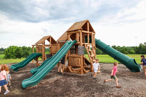 a group of children playing on a playground at Block of 4 Lodges at Eden Reserve - For Groups in Williamstown