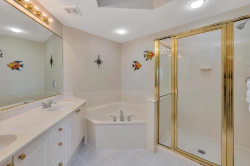Un baño blanco con ducha y lavabo. en St. Simons Grand #219, en Saint Simons Island