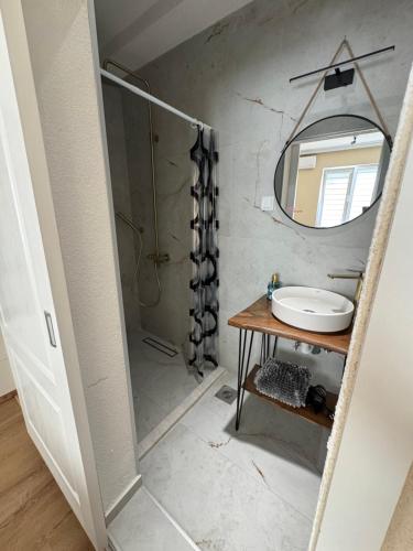 a bathroom with a sink and a mirror at Veljanov Suites in Negotino