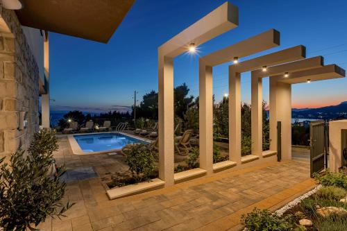 a villa with a swimming pool at night at Blue Dream - La Luna Residence in Tučepi