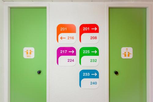 two doors with different colored numbers on them at Hotel First Eco Dieppe in Dieppe