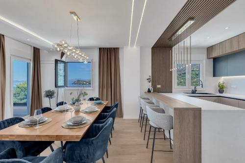a kitchen and dining room with a long table and chairs at Blue Dream - La Luna Residence in Tučepi