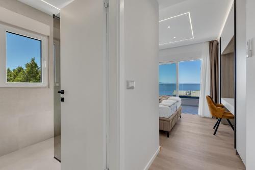 a bedroom with a bed and a view of the ocean at Blue Dream - La Luna Residence in Tučepi