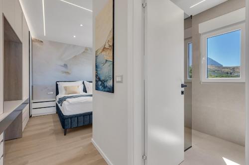 a bedroom with a bed and a window at Blue Dream - La Luna Residence in Tučepi