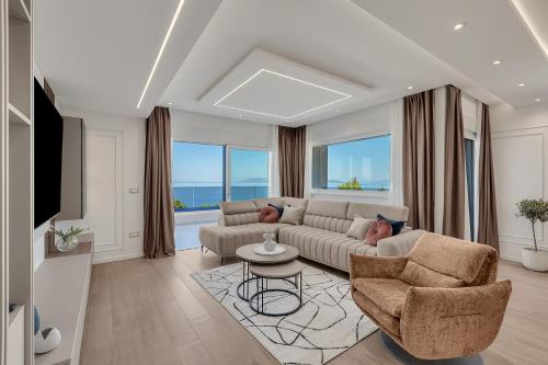 a living room with a couch and chairs and a tv at Blue Dream - La Luna Residence in Tučepi
