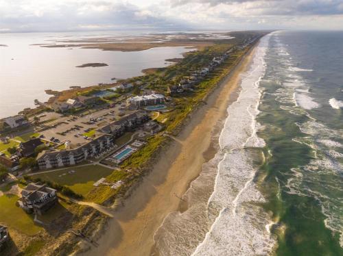 an aerial view of a beach with houses and the ocean at The Sanderling in Duck