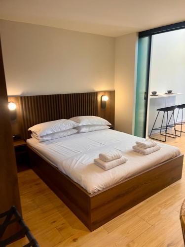 a bedroom with a large bed with towels on it at Aeraki Apartments in Kavála