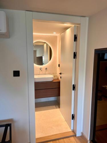 a bathroom with a sink and a mirror at Aeraki Apartments in Kavála