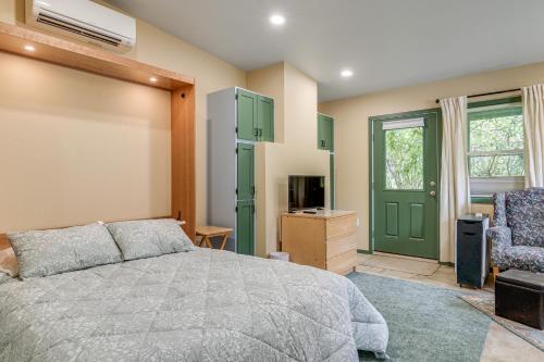 a bedroom with a bed and a green door at Less Than half Mi to OSU Studio in Corvallis Near Parks in Corvallis