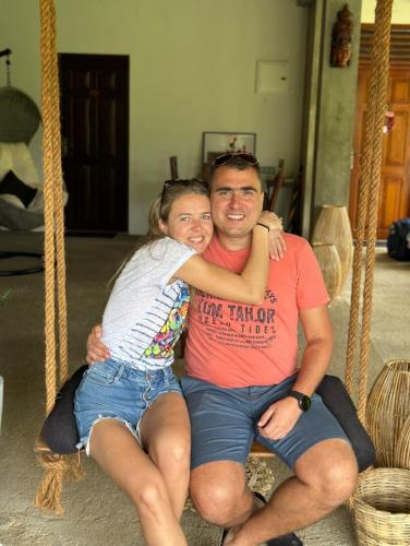 a man and a woman sitting on a swing at Tantra Ella Lodge in Ella