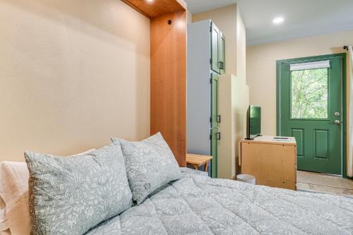 a bedroom with a bed and a green door at Less Than half Mi to OSU Studio in Corvallis Near Parks in Corvallis