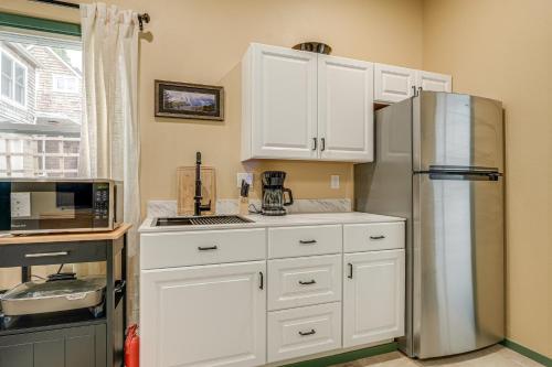 a kitchen with white cabinets and a stainless steel refrigerator at Less Than half Mi to OSU Studio in Corvallis Near Parks in Corvallis