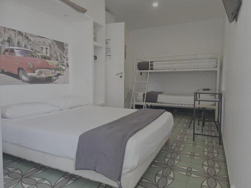 a bedroom with a bed and a car on the wall at Hotel Le Centre in Le Boulou