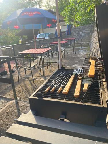 a grill with a bunch of hot dogs on it at Apartmány Bramborka in Janov nad Nisou