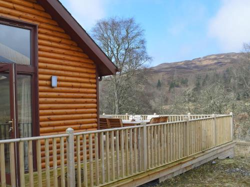 a log cabin with a porch and a deck at Frith View in White Bridge