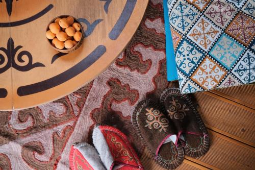 a pair of shoes and a bowl of eggs on a table at Family Eco Farm Getaway in Ryskulovo