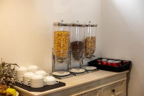 a shelf with a vase filled with food and cups at Villa Turistica de Bubion in Bubión