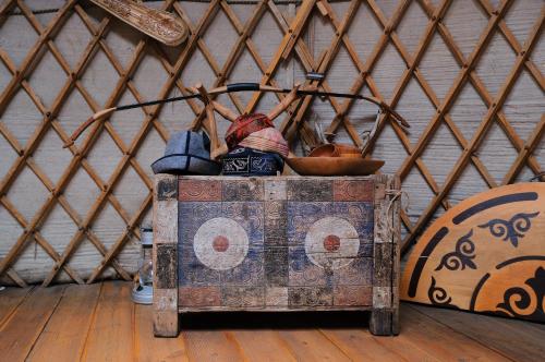 a trunk with a doll sitting on top of it at Family Eco Farm Getaway in Ryskulovo